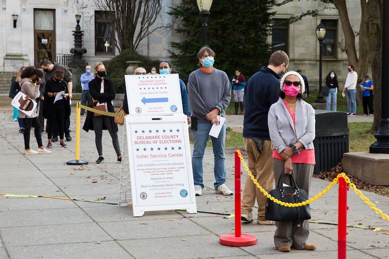Jacqueline St. Germain (right) waits in line to apply for a mail in ballot at the Delaware County Bureau of Elections Voter Service Center in Media, PA on the last day to do so, October 27, 2020. (Rachel Wisniewski / For the Inquirer)