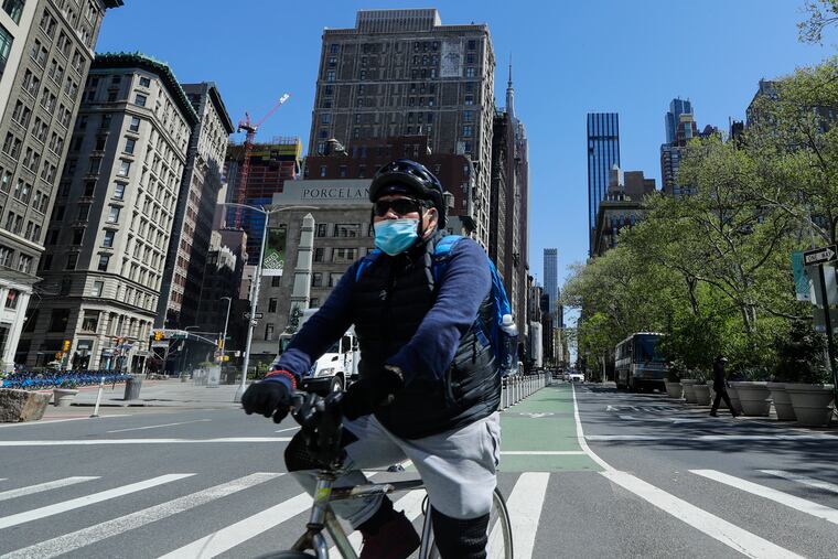 A cyclist wears a protective mask near Madison Square Park in New York.