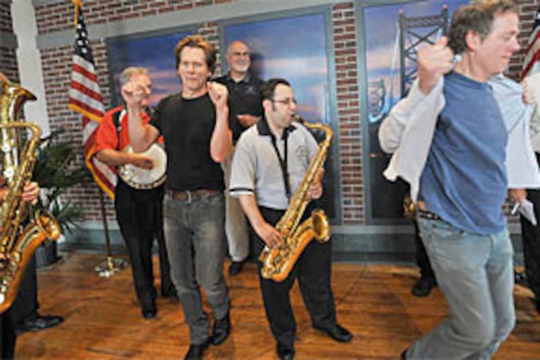 Ready for Two Street? Carmen Vitanza of Greater Overbrook plays sax, while the Bacon Brothers - Kevin (left) and Michael - strut. (Sharon Gekoski-Kimmel / Staff Photographer)