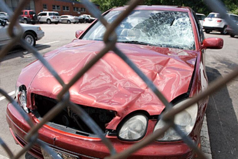 Joseph Genovese's Lexus sedan is seen here at the police impound lot. Genovese is accused of hitting two women as they crossed the street after a Phillies game. (Jessica Griffin / Daily News)