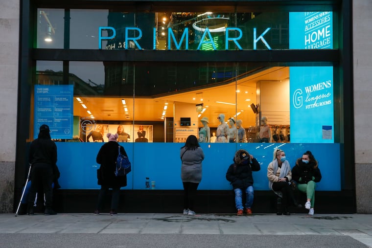 Customers line up outside a Primark clothing store ahead of its reopening on Oxford Street in London on April 12.