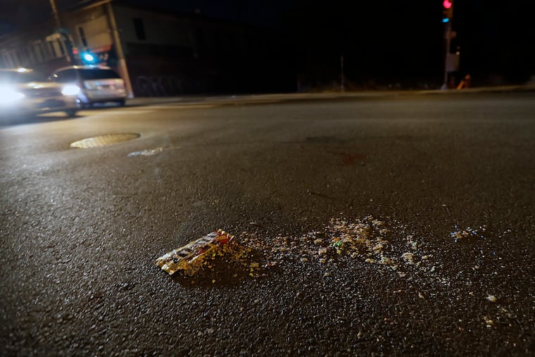 Blood and M&M’s left in the road after a teenage girl was shot and killed by random gunfire when she got off a bus at North 22nd Street and Sedgley Avenue in North Philadelphia.