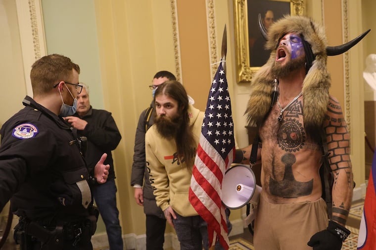 Protesters interact with Capitol Police inside the U.S. Capitol Building on Wednesday, Jan. 6, 2021 in Washington, D.C. Congress held a joint session today to ratify President-elect Joe Biden's 306-232 Electoral College win over President Donald Trump. A group of Republican senators said they would reject the Electoral College votes of several states unless Congress appointed a commission to audit the election results.