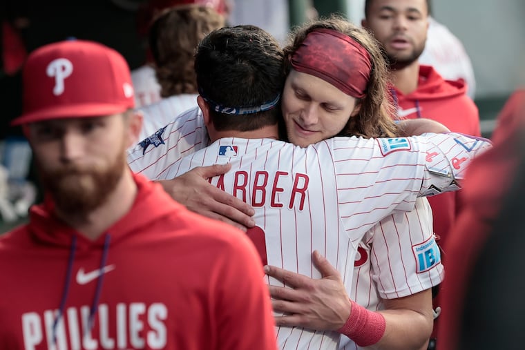 Kyle Schwarber and Alec Bohm hug in the dugout after they both hit home runs in the third inning against the Colorado Rockies on Saturday.
