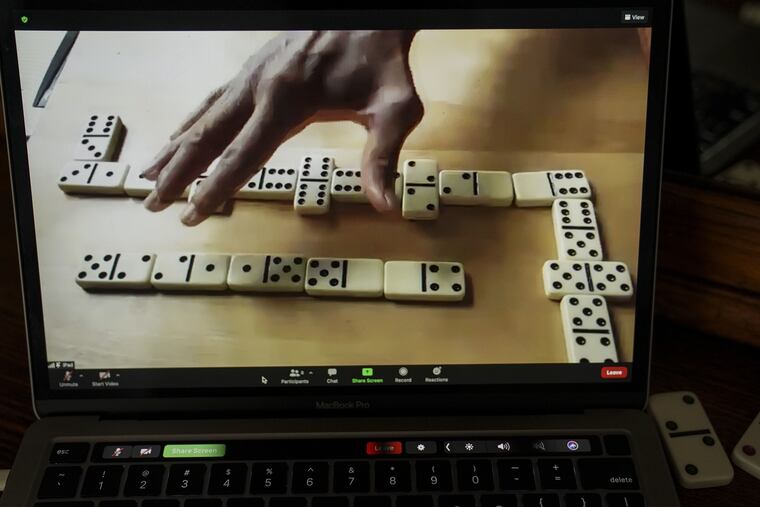 Howard Davis hosts a game of dominoes on Zoom from his home on Sept. 19.