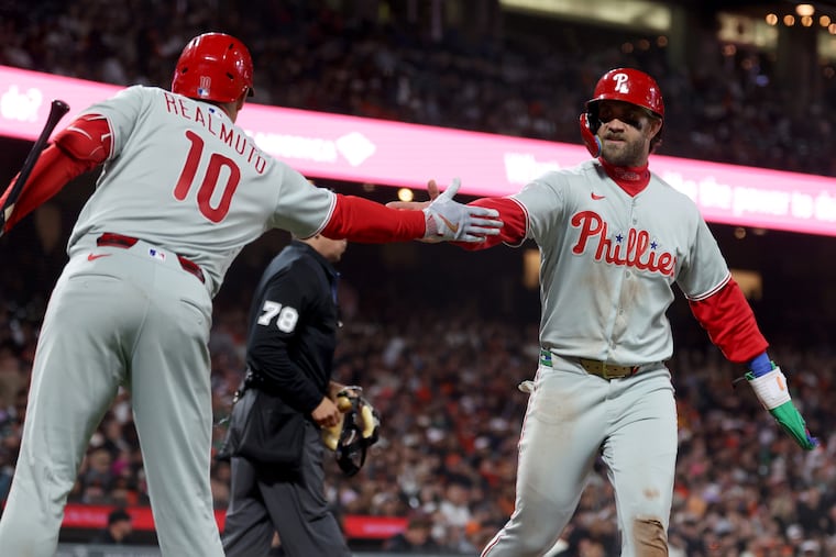 Bryce Harper (right) drove in three runs in the Phillies' 6-4 win.