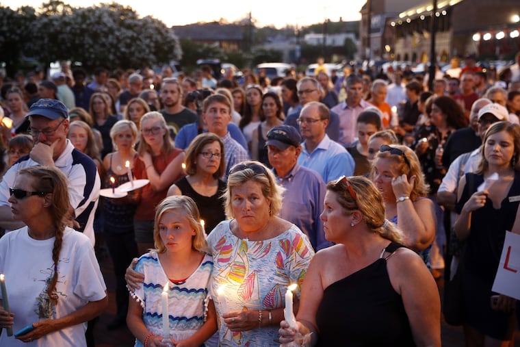 Mourners stand in silence during a vigil in response to a shooting at the Capital Gazette newsroom, Friday, June 29, 2018, in Annapolis, Md. Prosecutors say 38-year-old Jarrod W. Ramos opened fire in the newsroom the day prior.