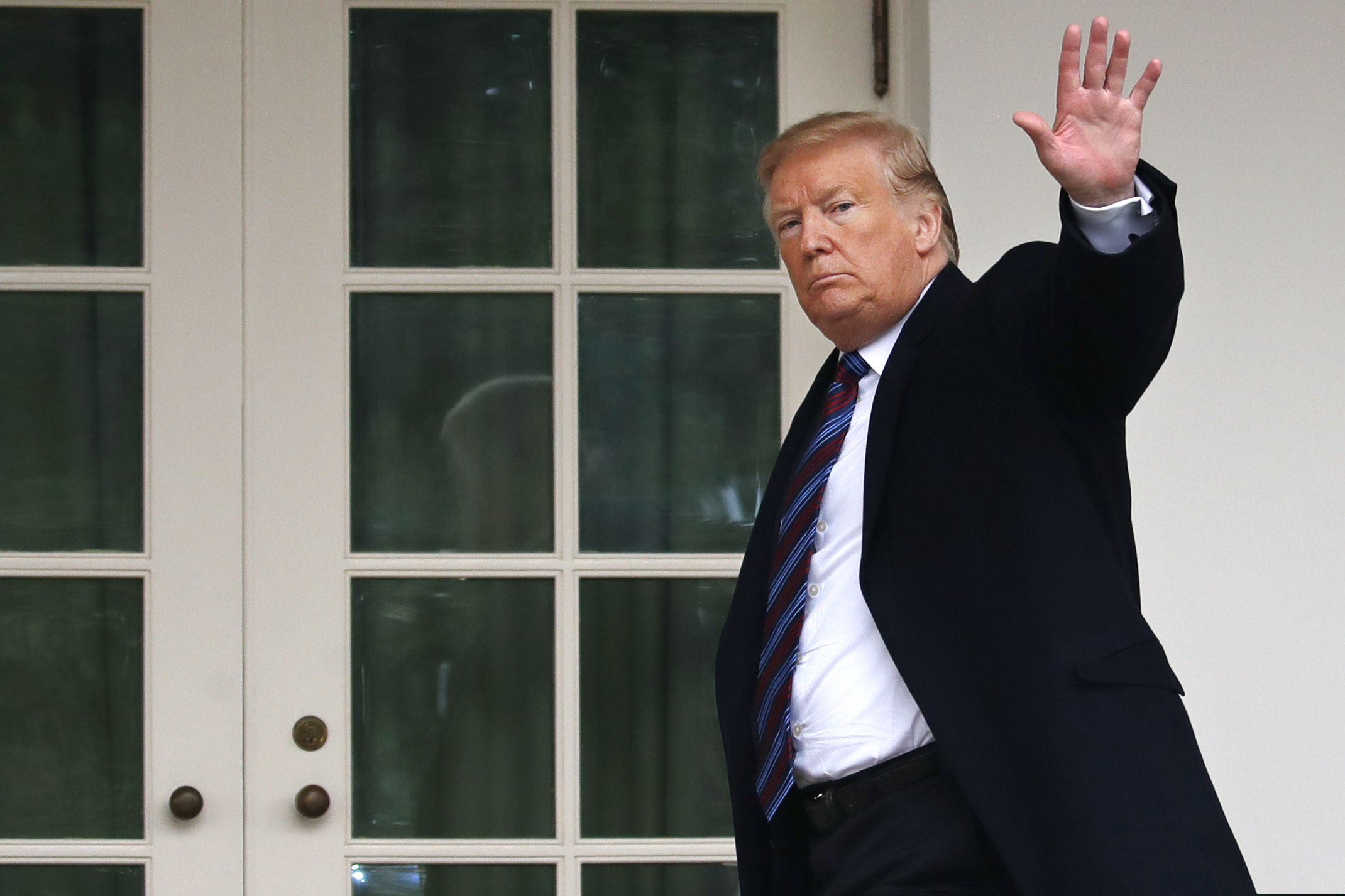 President Donald Trump waves as he leaves the Rose Garden of the White House after speaking and taking questions from the media after his meeting with Congressional leaders on border security, Friday, Jan. 4, 2019, at the White House in Washington.