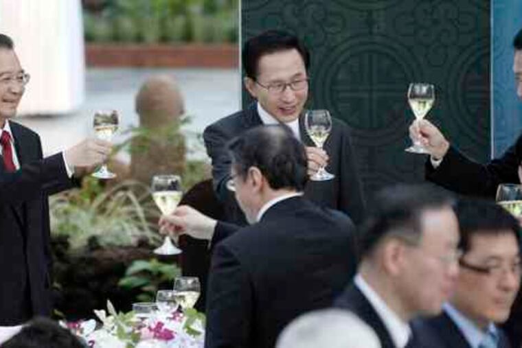 At a weekend summit in South Korea , leaders (from left) Wen Jiabao of China, Lee Myung-bak of South Korea, and Yukio Hatoyama of Japan toast. Saturday's talks focused on trade.