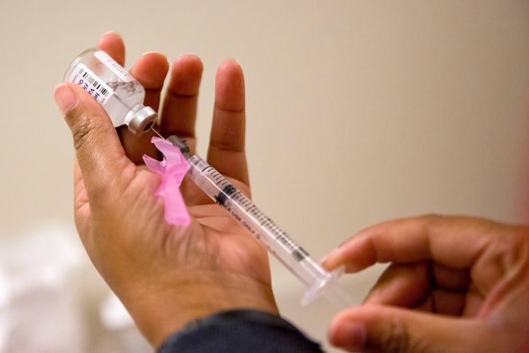 A nurse prepares a flu shot at the Salvation Army in Atlanta.