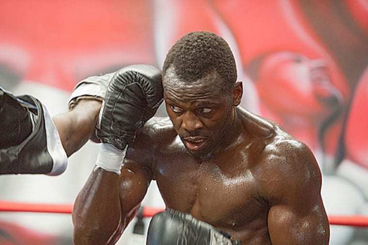 Philadelphia heavyweight boxer Steve Cunningham slips a punch during a work out in the ring at DSG Boxing Gym in Philadelphia July 22, 2015. He is training for an upcoming fight against Antonio Tarver August 14th in Brooklyn.