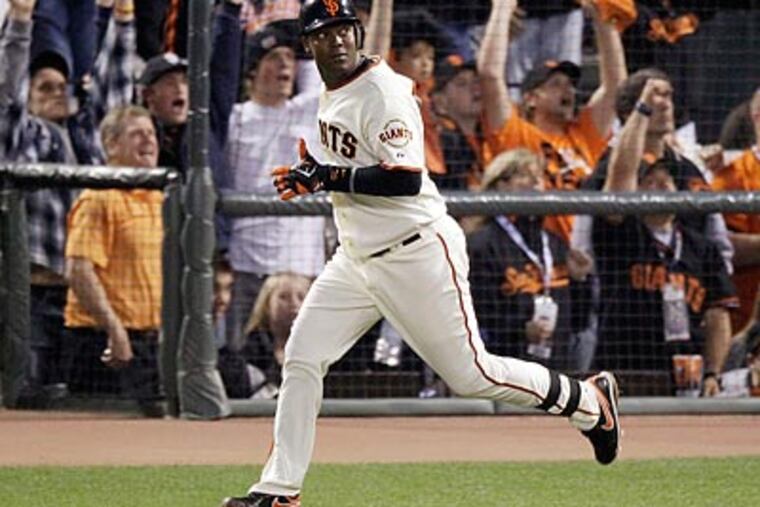 Edgar Renteria watches his fifth-inning home run in Game 2 of the World Series. The Giants won, 9-0. (AP/Eric Gay)