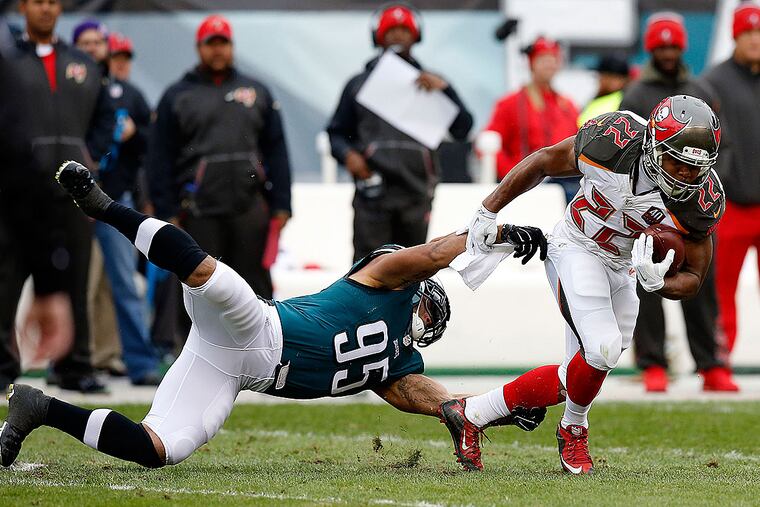 Mychal Kendricks tries to stop Buccaneers running back Doug Martin.