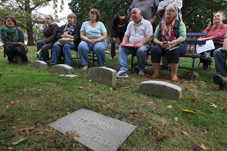 At Lucretia Coffin Mott's graveside in Historic Fair Hill Burial Ground in North Philadelphia, people listen to a speaker at the program "Lucretia Mott: The Greatest American Woman."