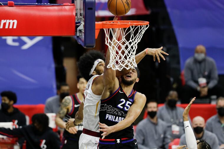Sixers guard Ben Simmons gets hit by the Cavaliers' Jarrett Allen driving for a layip during the first quarter.