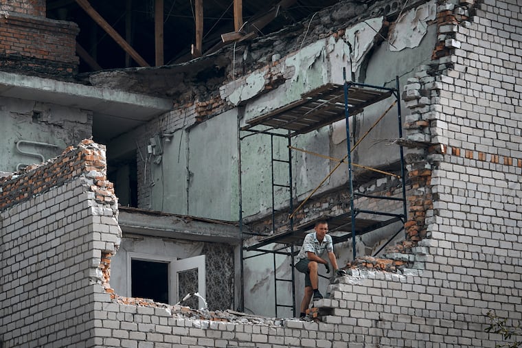 A man looks out from an apartment destroyed after Russian shelling in Nikopol, Ukraine, on Monday.