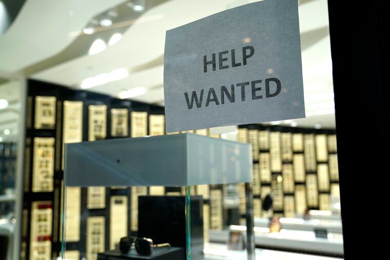 A Help Wanted sign is posted at a Designer Eyes store at Brickell City Centre, Friday, Nov. 6, 2020, in Miami.