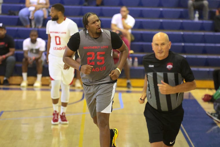 Dionte Christmas (center) of the gray team reacts after his 3-pointer put his team ahead to stay in overtime.