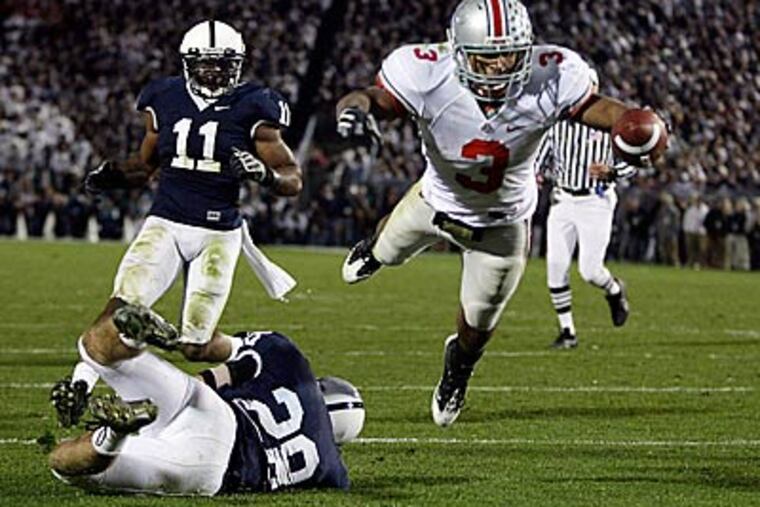 Ohio State running back Brandon Saine (3) dives into the end zone for a touchdown after breaking a tackle attempt by Penn State's Drew Astorino (28) and Navorro Bowman (11) during the second half. (AP Photo / Carolyn Kaster)