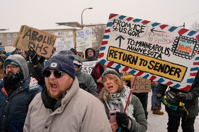 People march and gather near the post office during a protest, Sunday, Jan. 18, 2026, in Minneapolis.
