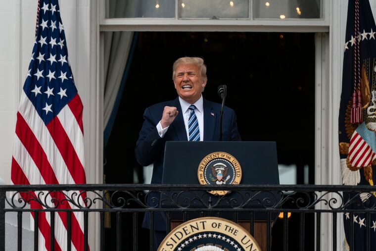 President Donald Trump speaks from the Blue Room Balcony of the White House to a crowd of supporters on Saturday.