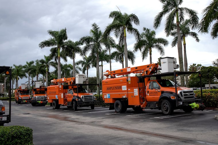 A fleet of Asplundh trucks, a tree service company, are lined up in Delray Plaza shopping center while standing by in the area ready for assist in case Hurricane Dorian approached South Florida. Dorian is stalled about 100 miles to the East over the ocean moving slowly on Monday, Sept. 2, 2019. (Pedro Portal/Miami Herald/TNS)