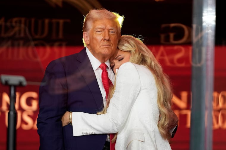 President Donald Trump embraces Erika Kirk at the memorial service for her husband, conservative activist Charlie Kirk on Sunday at State Farm Stadium in Glendale, Ariz.