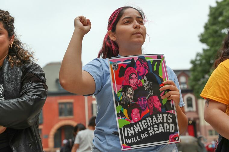 Melanie Machuca raises a fist outside of the Statehouse Annex in Trenton, where immigration groups rallied on June 22 to demand greater investment in immigrant communities amid the state's billions in budget surplus. Immigrant leaders in New Jersey and Pennsylvania say they need more from the Biden administration.