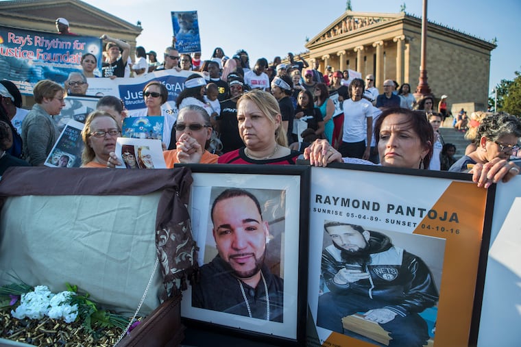 A group of women, including Lisa Espinosa, right, stand with hands clasped as relatives and friends of the victims of gun violence stand on the Art Museum steps on June 15, 2017.