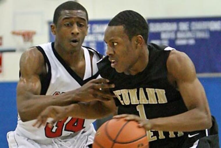 Neumann-Goretti's Hanif Sutton moves on Octorara's Dequan Newton during the first quarter. (Steven M. Falk/Staff Photographer)