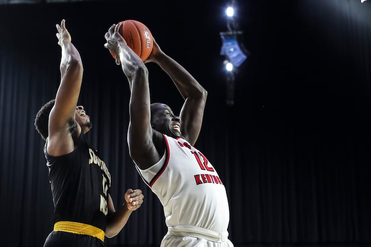 Western Kentucky forward Moustapha Diagne (12) grabbing a rebound against Southern Miss during a March game.