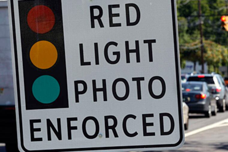 A sign warns of red-light camera enforcement on Route 1 in Lawrence Township, N.J. MEL EVANS / Associated Press