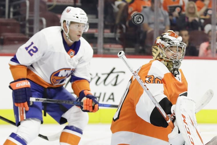 Goaltender Michal Neuvirth looks for the puck during the first period of the Flyers' 3-1 preseason win over the Islanders Monday night.