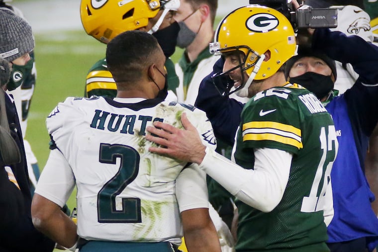 Green Bay Packers quarterback Aaron Rodgers (right) talking with Eagles quarterback Jalen Hurts after a December 2020 game at Lambeau Field. The Eagles and Packers face off tonight on NBC's "Sunday Night Football."