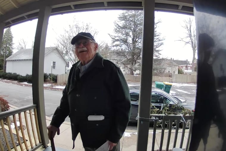 Doug Turner delivering an invitation for his winter party to his neighbor, Michelle Hernandez, in Bucks County, Pennsylvania.