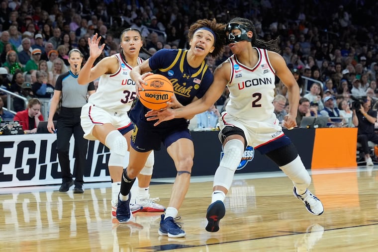 Notre Dame guard Hannah Hidalgo (center) drives through UConn's pressure in the second half Sunday. She finished with 22 points and 11 rebounds.