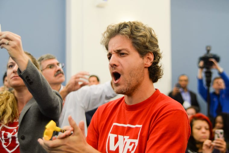 George Bezanis, parent and teacher, celebrates the historic vote for the SRC to dissolve itself Nov. 16.