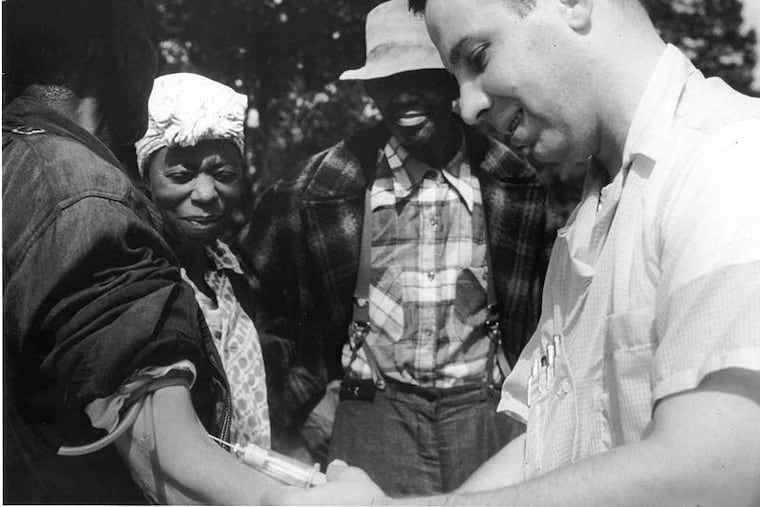 A doctor draws blood from a patient in the Tuskegee syphilis study, which helped create lingering distrust of clinical trials.