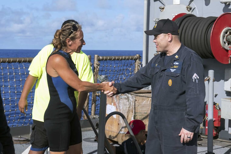 Jennifer Appel is welcomed aboard by USS Ashland Command Master Chief Gary Wise after her rescue.