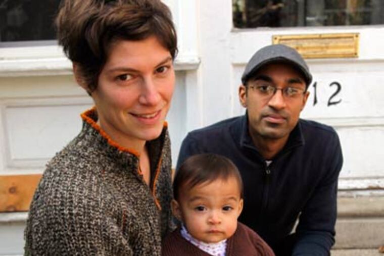 Elyse Fenton with husband Peenesh Shah and their daughter, Mira Shah, at their West Philadelphia home. (Laurence Kesterson / Staff Photographer)
