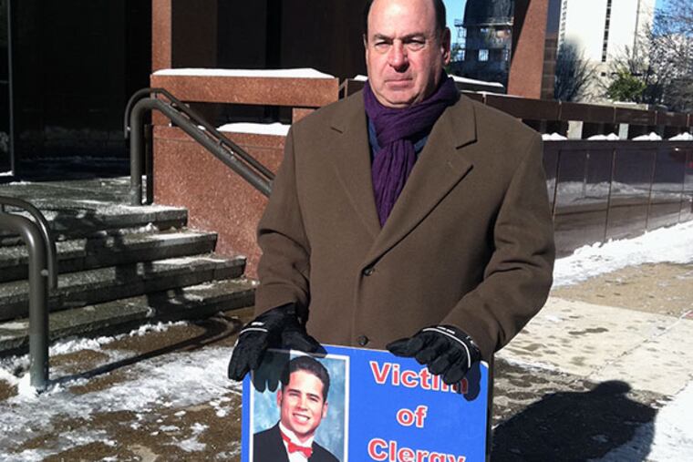Arthur Baselice Jr. stands outside the Archdiocese of Philadelphia's headquarters on 17th Street in Center City, Friday, Jan. 3, 2014, as part of his monthly vigil to protest the Archdiocese's handling of clergy sexual abuse. Baselice blames the former president of Archbishop Ryan High School, Father Charles Newman, and another Franciscan friar, for the death of his son, Arthur Baselice III. (Julie Shaw/Staff)