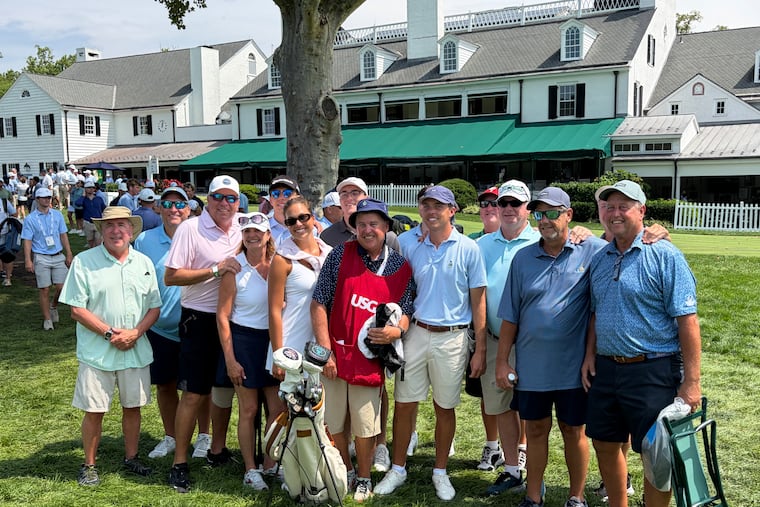 Drue Nicholas (center) poses for a photo alongside his caddy, friends, and family on Monday.