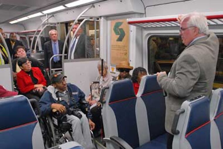 SEPTA's Dave Casper explains the new features of the railcar of the future to members of the SEPTA advisory board for accessable transportation during a tour of the car at Surban Station. (Ron Tarver/Staff Photographer)
