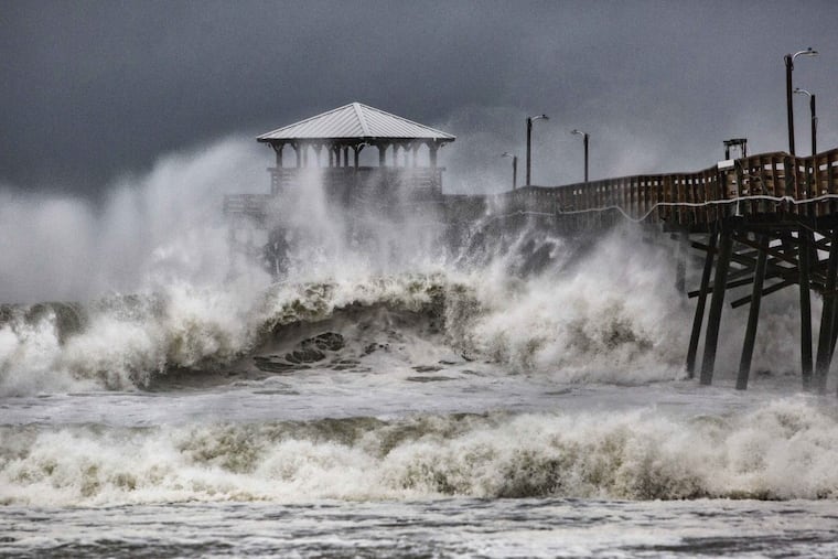 Waves slam the Oceana Pier & Pier House Restaurant in Atlantic Beach, N.C., Thursday, Sept. 13, 2018 as Hurricane Florence approaches the area.