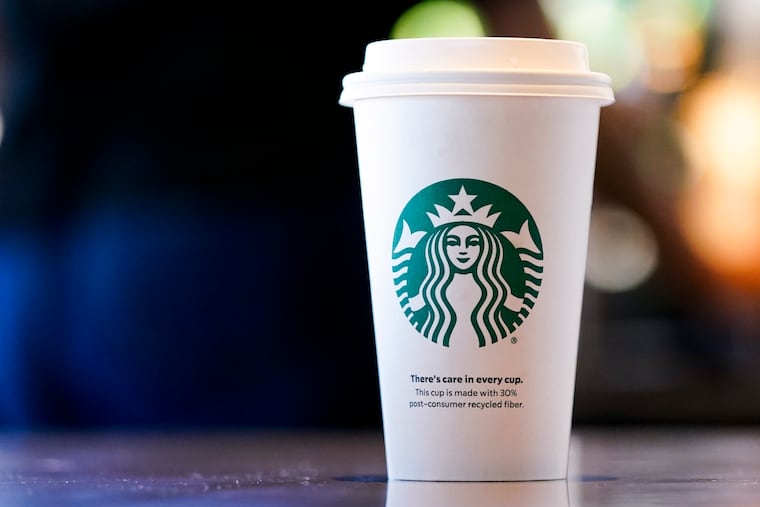 A single-use cup made from 30% post-consumer recycled fiber sits at a Starbucks retail location in June in Seattle.