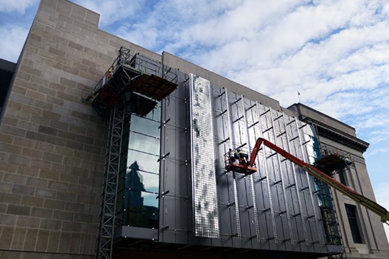 Ironworkers continue to assemble a nearly 3,000 square foot exterior structure known as a "Shimmering Wall" on the façade of the soon-to-open Nicholas and Athena Karabots Pavilion expansion at The Franklin Institute October 22, 2013. (TOM GRALISH / Staff Photographer)