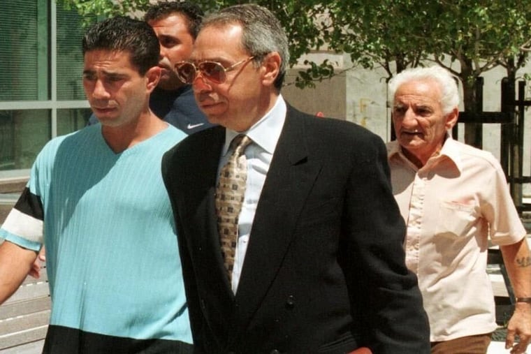 Joseph Santaguida, center, walking alongside his then-client Joseph "Skinny Joey" Merlino, left, a reputed Philadelphia mobster, in an undated photo. Mr. Santaguida died from the coronavirus on May 13, 2020, his son said.