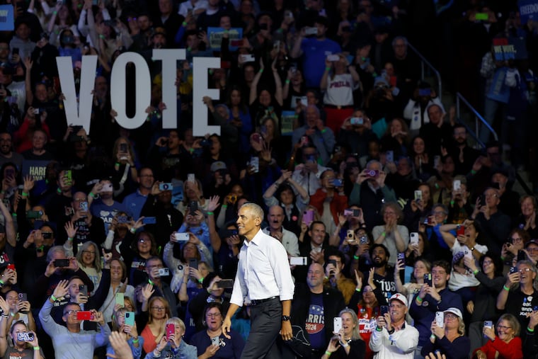 Former President Barack Obama takes the stage during a rally for Vice President Kamala Harris' campaign at the Liacouras Center on Temple University's campus in 2024.