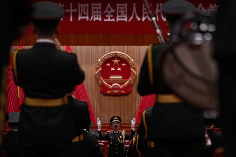 A Chinese military conductor gestures as he instructs his music band members during a rehearsal for the closing session of the National People's Congress (NPC) at the Great Hall of the People, in Beijing, China, Thursday, March 12, 2026.