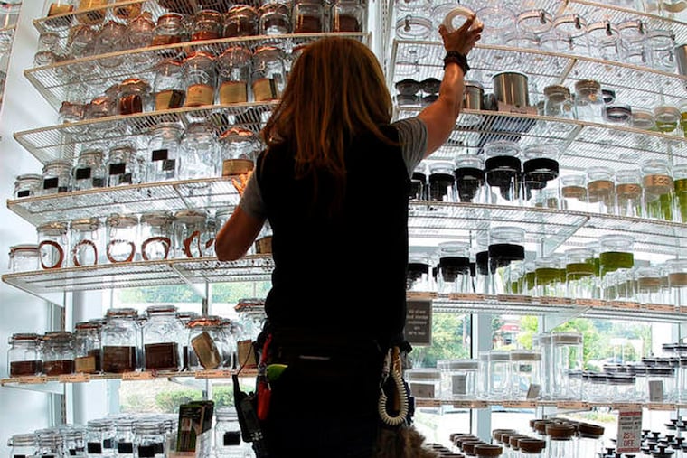 Linda Campbell, a sales associate, arranging glass containers at the Cherry Hill store.
